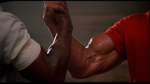 http://www.inpapasbasement.com/wp-content/uploads/2011/08/Predator_Arnold_Schwarzenegger_Carl_Weathers_Biceps_Arm_Wrestling_Handshake.jpg